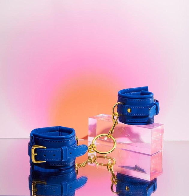 Navy blue Orion handcuffs with gold details