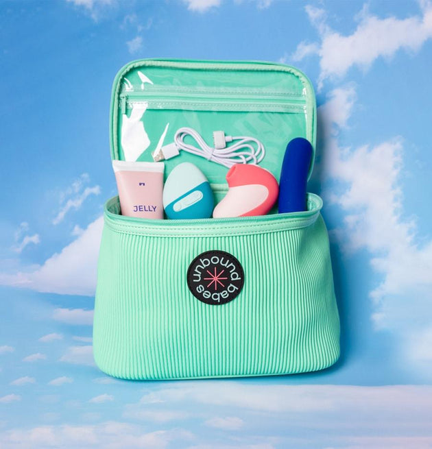 sea green storage bag with Jelly, Puff, Bean in the main pocket, and a white USB charger in a clear zippered pocket on the top